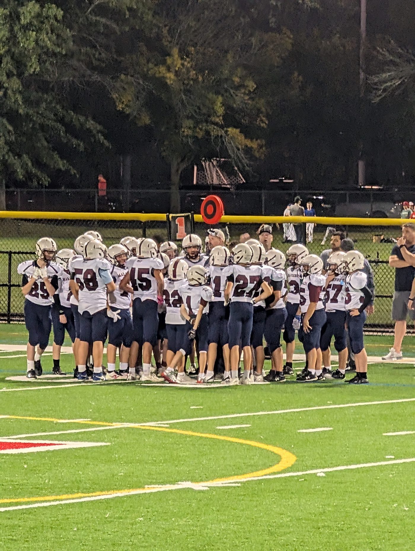 Players huddling on the field during a game